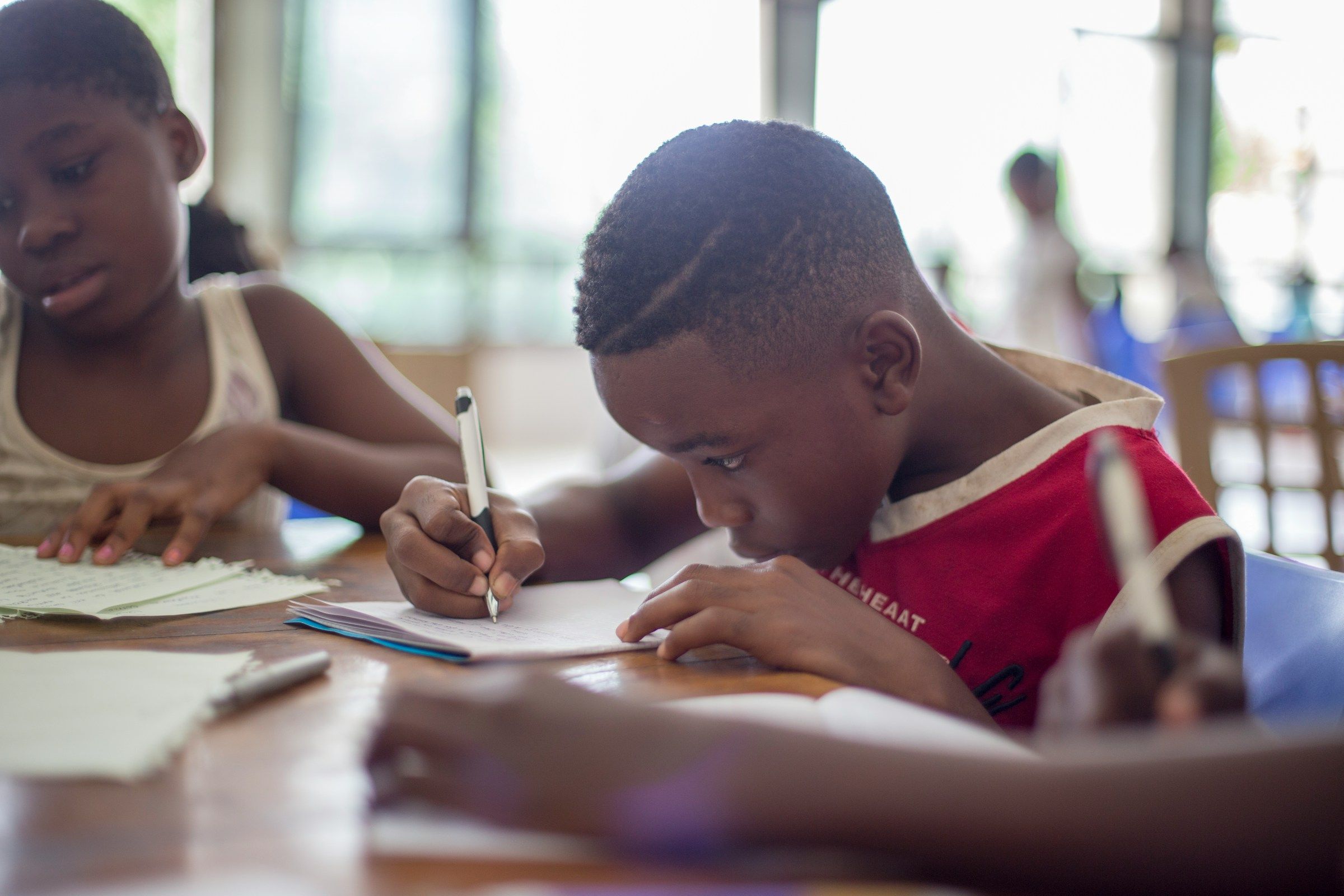 African children writing on a book